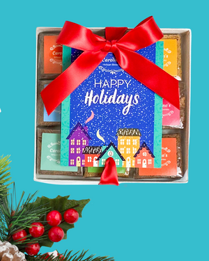 Box of chocolates with a festive design and red ribbon on a blue background