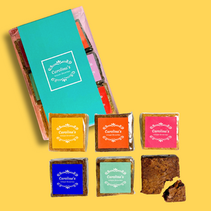 Assorted chocolate bars with colorful packaging on a yellow background