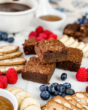 brownies and fruits and crackers on a sweet charcuterie board